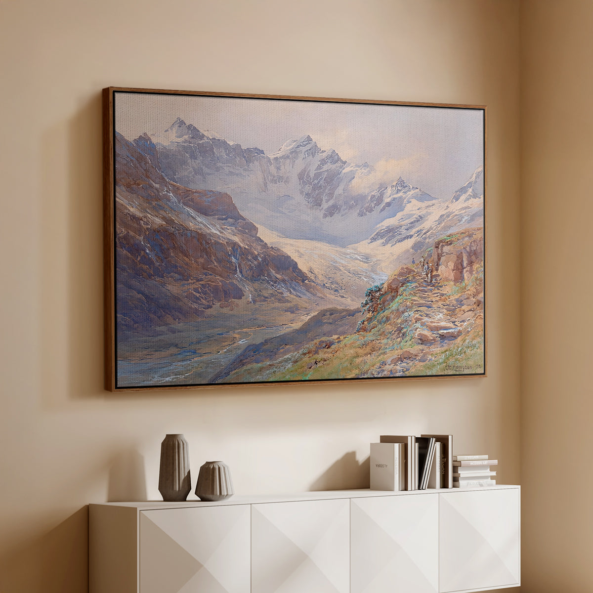 Walnut floater framed canvas of Odenwinklkees with the Johannisberg, 1902 by Edward Theodore Compton, featuring a mountain scene with glacier stretching through rocky valley above a console cabinet in a minimalist entryway.