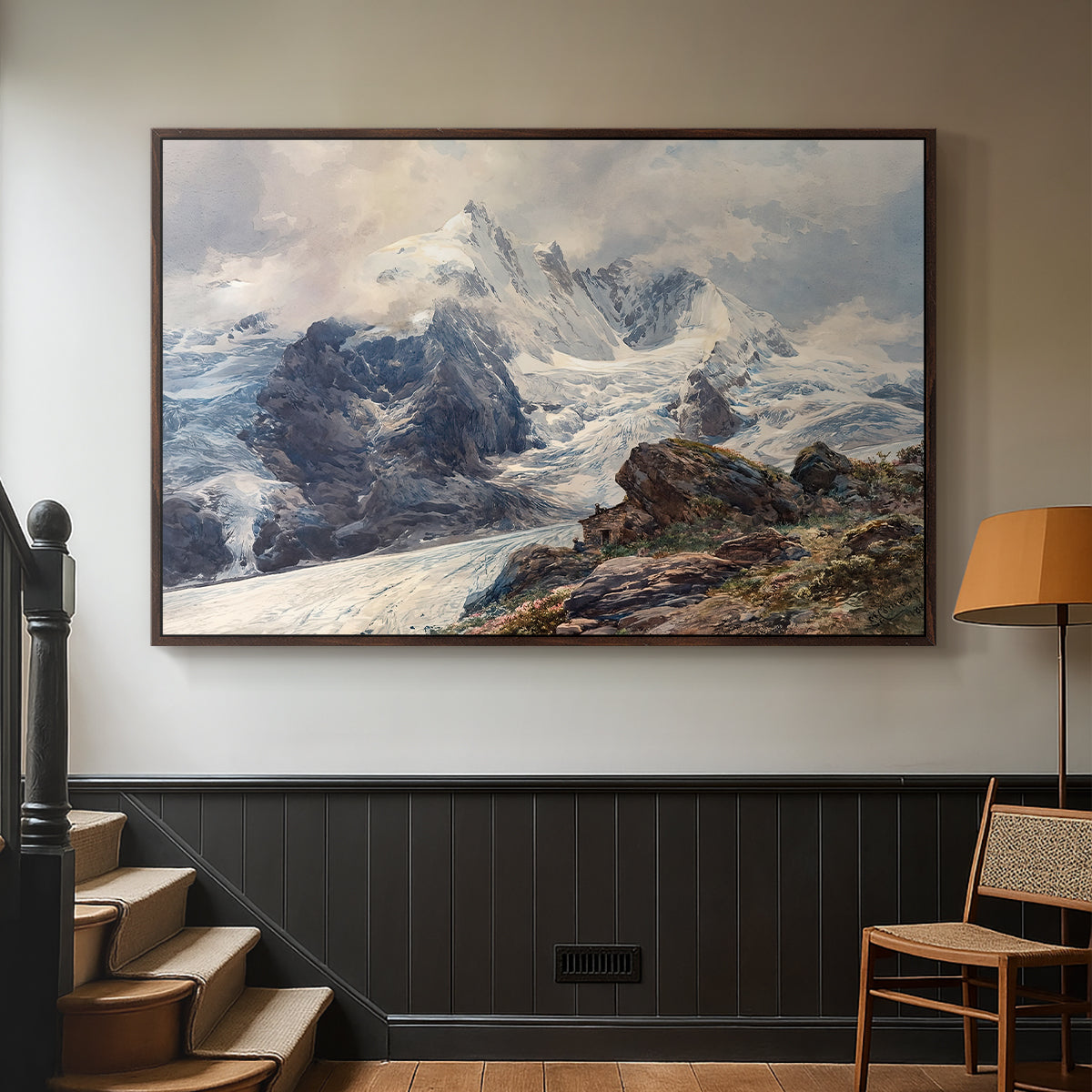 Walnut floater framed canvas featuring an alpine peak dominating surrounding terrain, displayed in a hallway near a staircase.