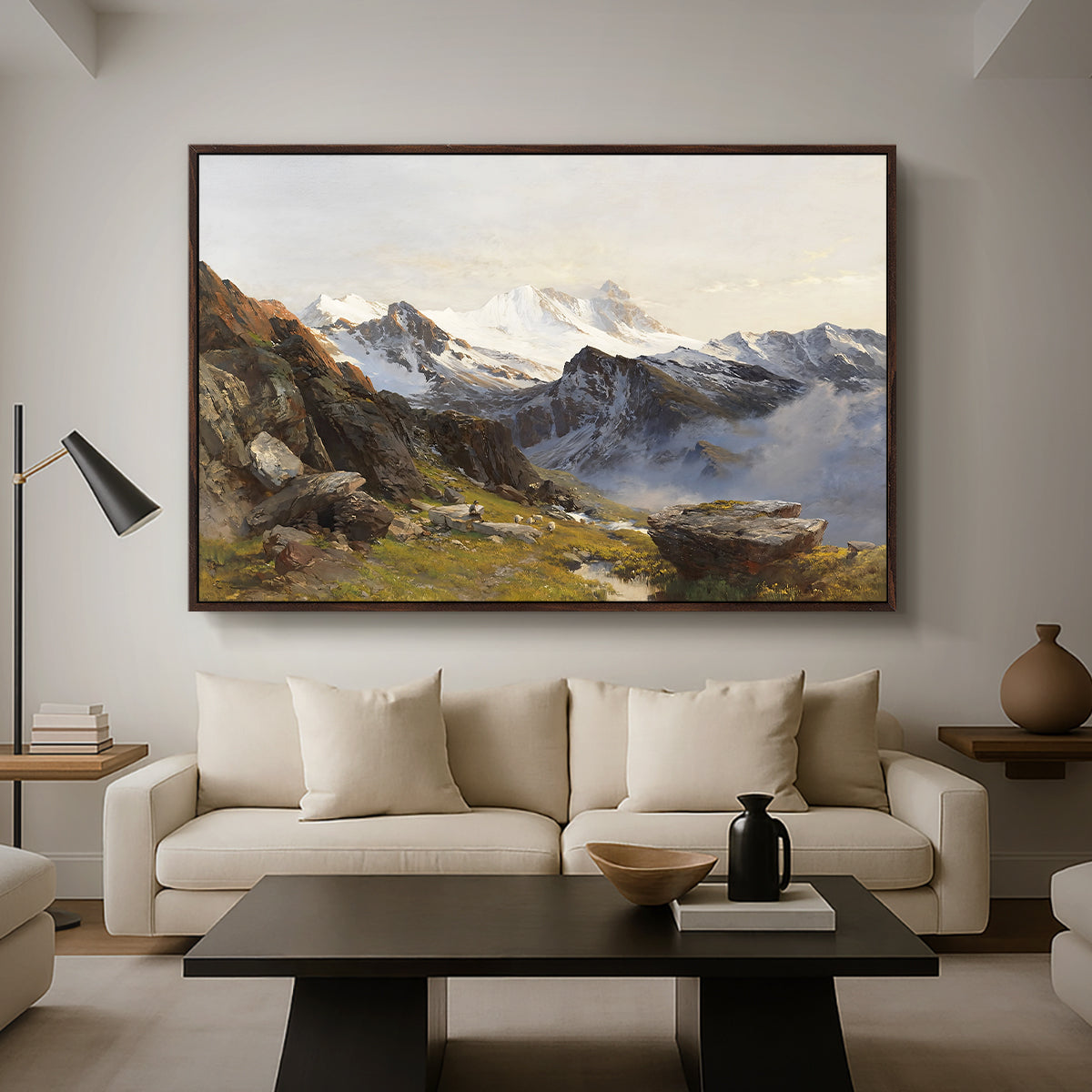 The Großglockner from the Prager Hut, 1890 by Edward Theodore Compton as a walnut floater framed canvas featuring a view of Großglockner peak from alpine hut overlooking valley, displayed above a sofa in a modern living room.