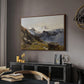 The Großglockner from the Prager Hut, 1890 by Edward Theodore Compton in a walnut floater framed canvas featuring an alpine vista with towering peak and foreground terrain, displayed above a desk in a dark home office interior.