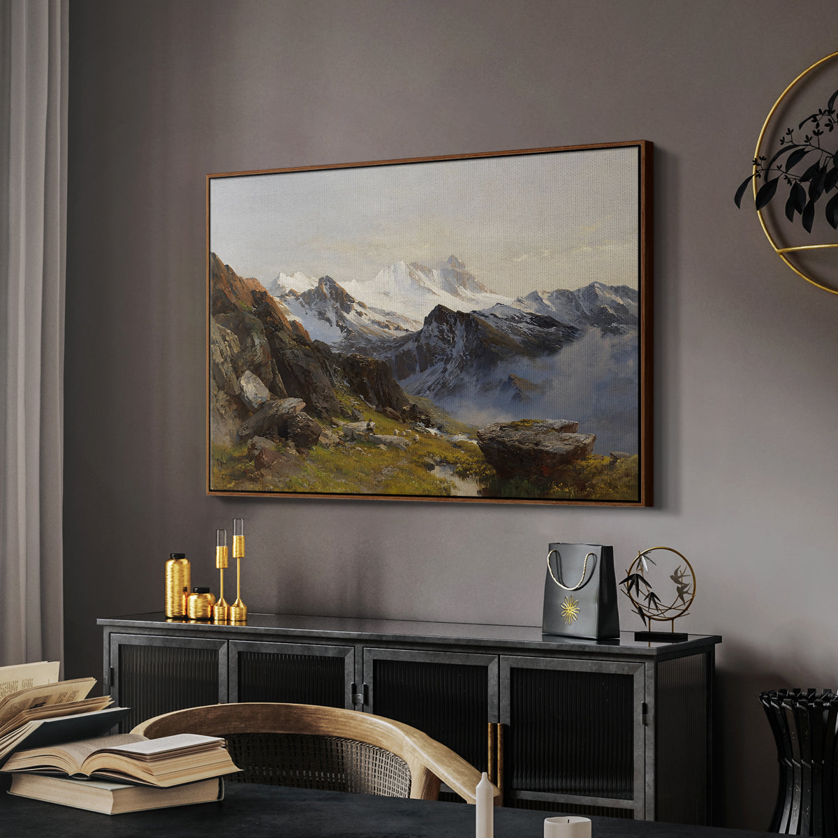 The Großglockner from the Prager Hut, 1890 by Edward Theodore Compton in a walnut floater framed canvas featuring an alpine vista with towering peak and foreground terrain, displayed above a desk in a dark home office interior.