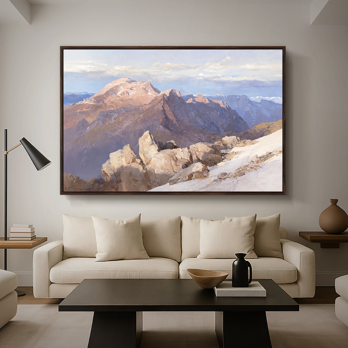 Hoher Göll from Watzmann-Hocheck, 1919 by Edward Theodore Compton as a walnut floater framed canvas featuring a distant mountain peak viewed from elevated ridge with sweeping landscape, displayed above a sofa in a modern living room.