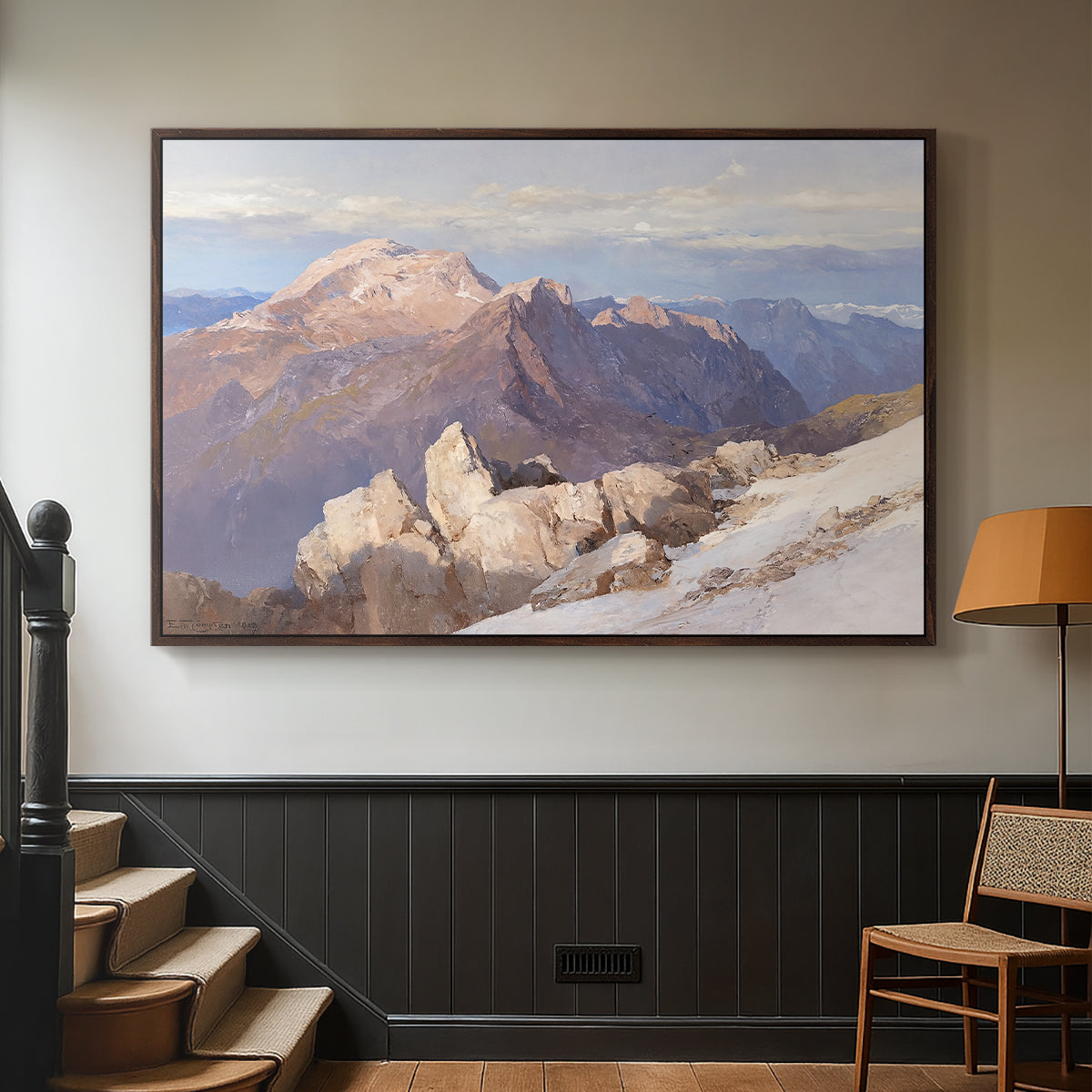 Walnut floater framed canvas featuring an expansive mountainous landscape with natural depth, displayed in a hallway near a staircase.