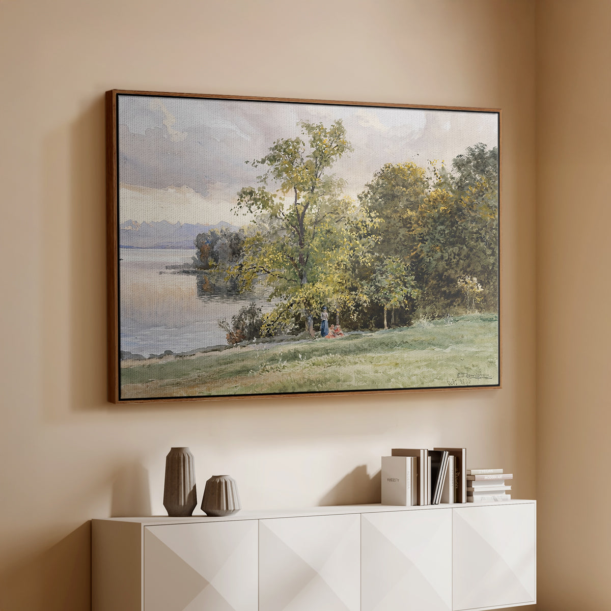 Walnut floater framed canvas of Landscape at Lake Starnberg, 1890 by Edward Theodore Compton, featuring a peaceful lake scene with reflections and surrounding greenery above a console cabinet in a minimalist entryway.
