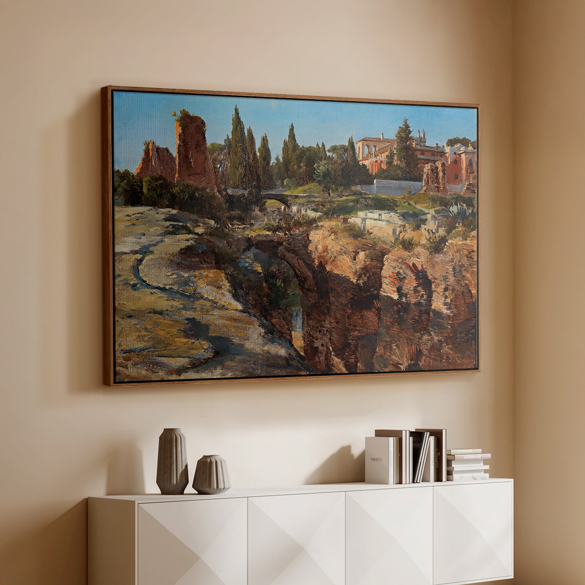 Walnut floater framed canvas of Palatine in Rome, c. 1921 by Edward Theodore Compton, featuring an architectural scene of ancient structures in sunlit environment above a console cabinet in a minimalist entryway.