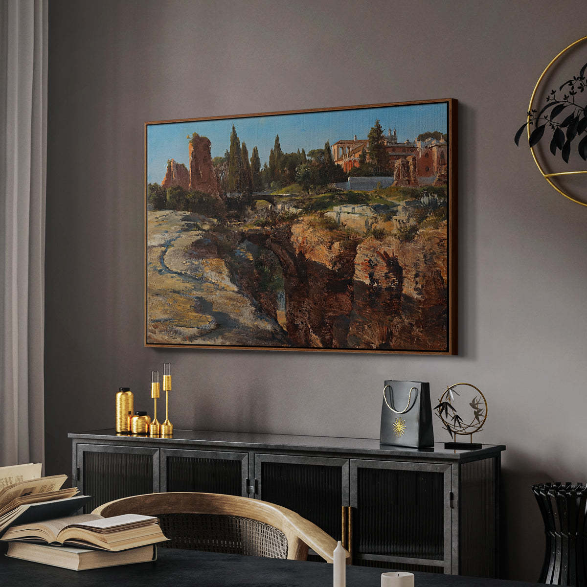 Palatine in Rome, c. 1921 by Edward Theodore Compton in a walnut floater framed canvas featuring a cityscape with classical ruins and surrounding terrain, displayed above a desk in a dark home office interior.