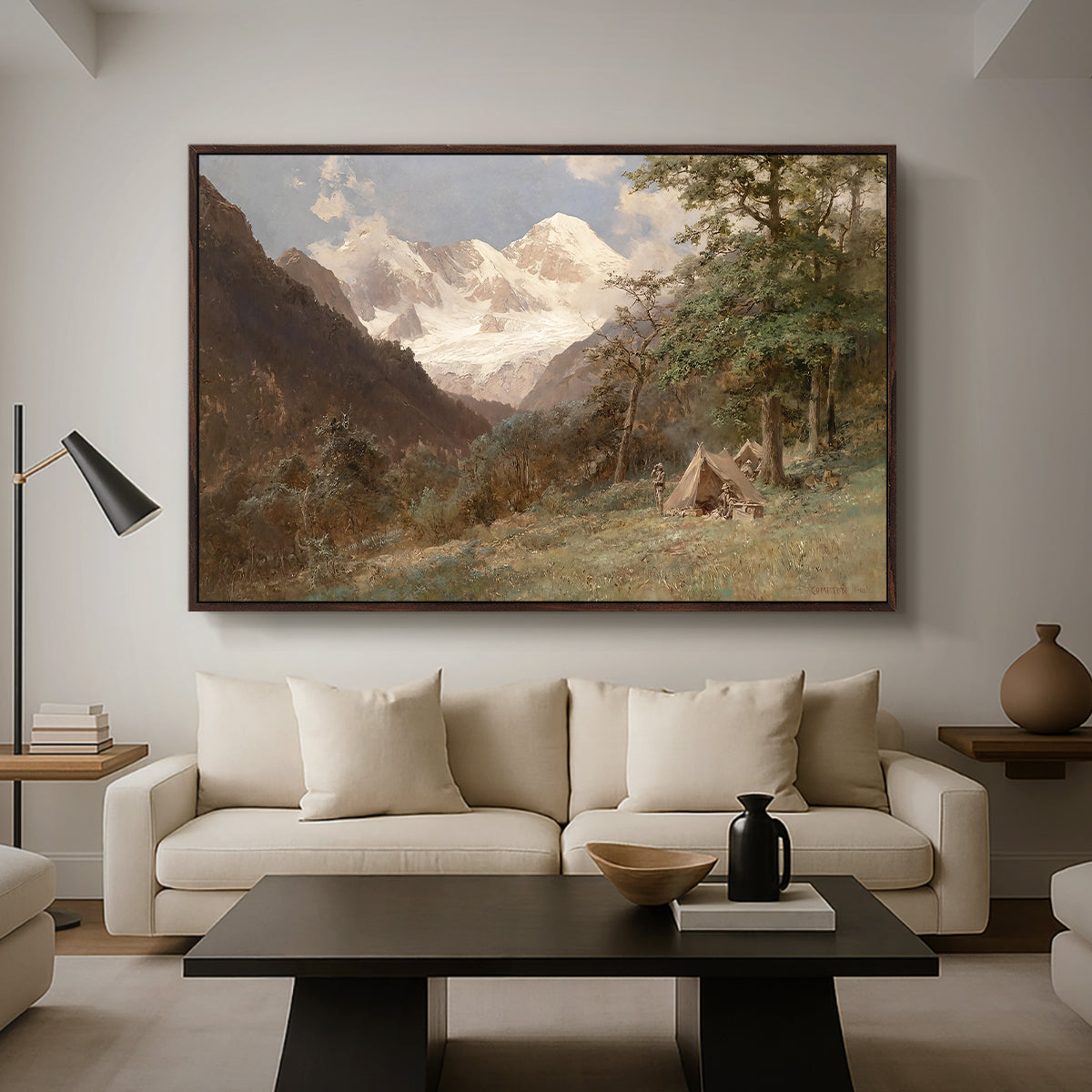 Landscape in the Caucasus, c. 1921 by Edward Theodore Compton as a walnut floater framed canvas featuring a mountainous landscape with rugged terrain and distant peaks, displayed above a sofa in a modern living room.
