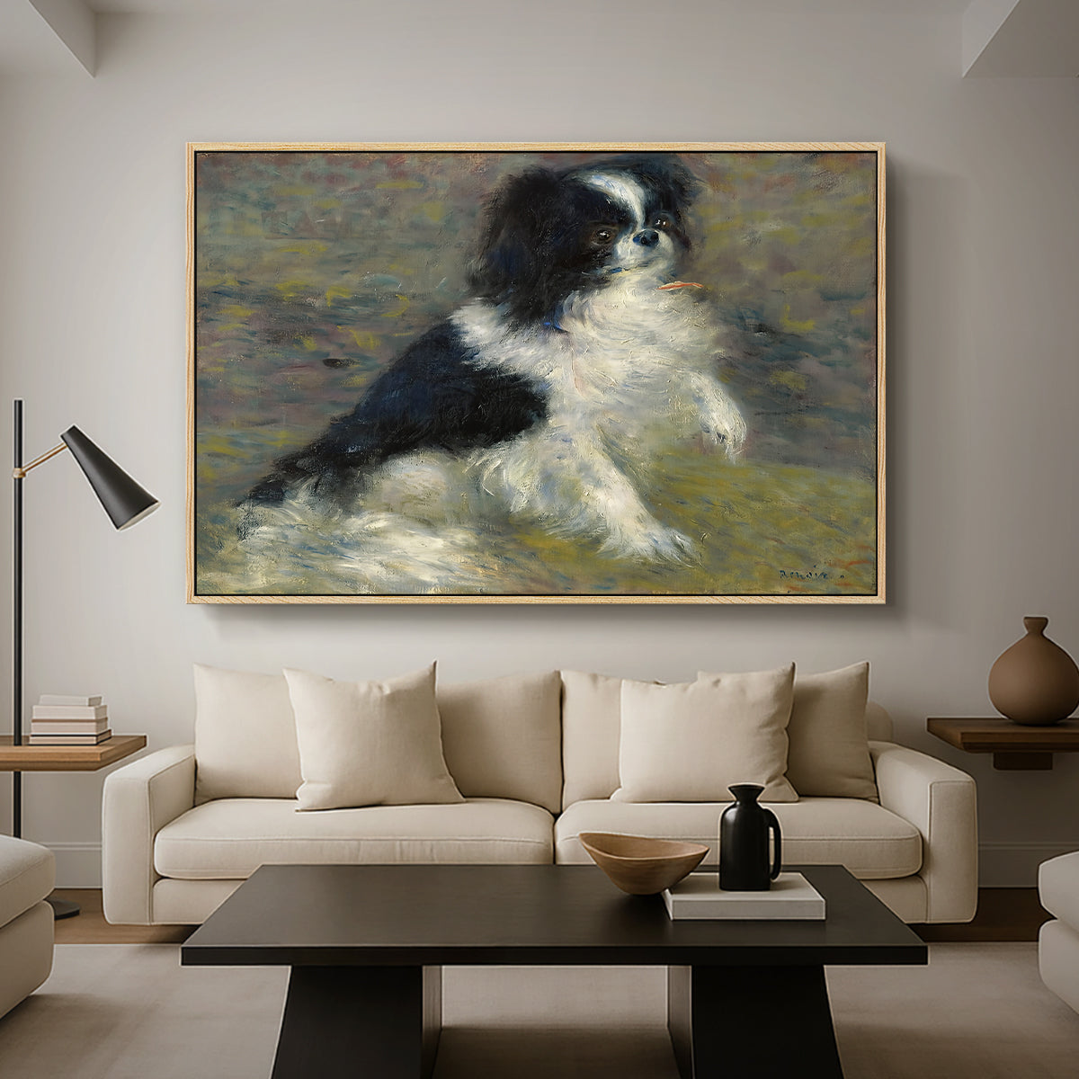 Tama, the Japanese Dog, c. 1876 by Pierre-Auguste Renoir as a natural wood floater framed canvas featuring a small black and white dog standing in shallow water with soft brushstrokes, displayed above a sofa in a modern living room.