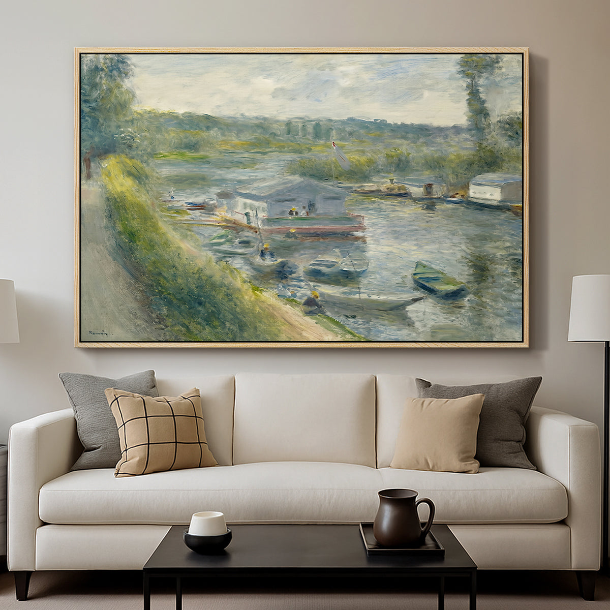Wash-House Boat at Bas-Meudon, c. 1874 by Pierre-Auguste Renoir displayed in a natural wood floater framed canvas above a sofa in a clean living room.