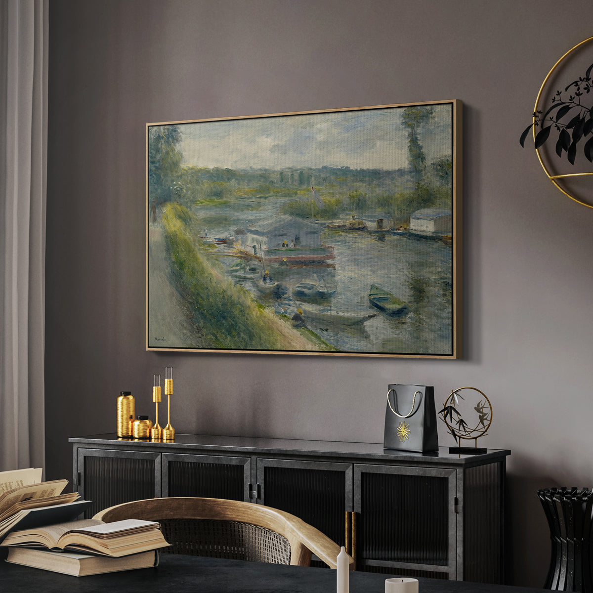 Wash-House Boat at Bas-Meudon, c. 1874 by Pierre-Auguste Renoir in a natural wood floater framed canvas featuring an impressionist depiction of working boat along calm waterway, displayed above a desk in a dark home office interior.