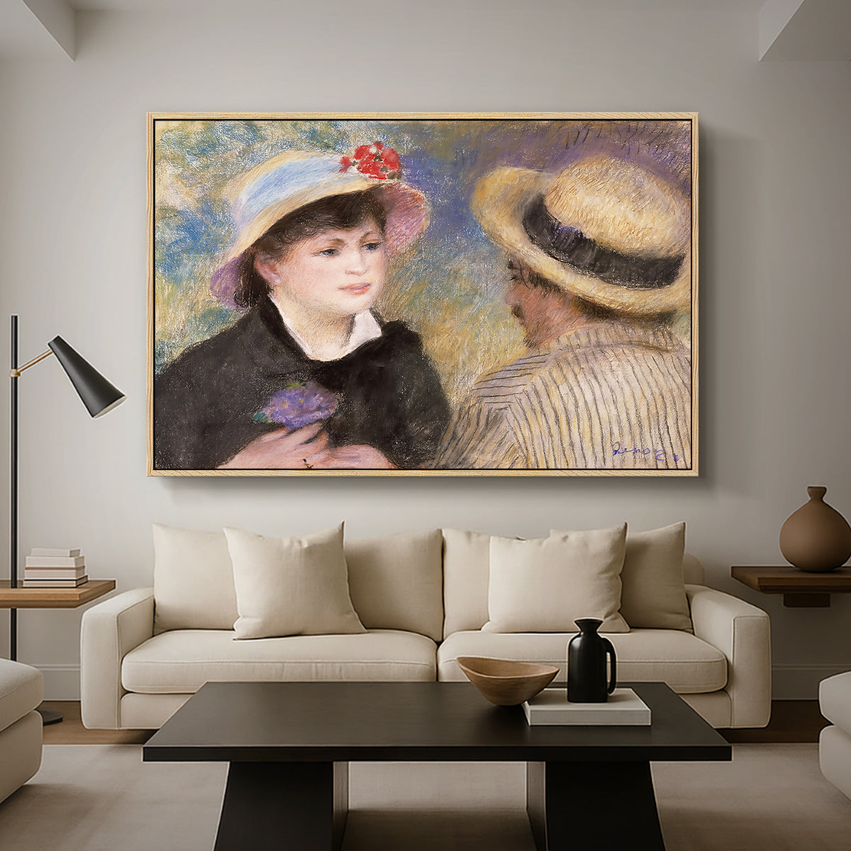 Boating Couple (Aline Charigot and Renoir), c. 1881 by Pierre-Auguste Renoir as a natural wood floater framed canvas featuring a close-up of a couple seated together outdoors with hats and soft sunlight, displayed above a sofa in a modern living room.
