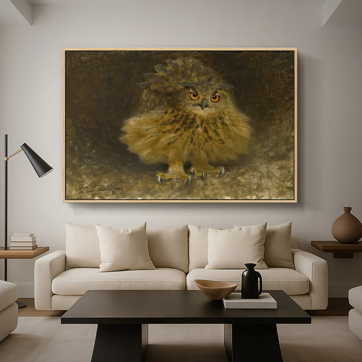 An Eagle Owl (Berguv), 1905 by Bruno Liljefors as a natural wood floater framed canvas featuring a large owl perched on branch in shadowy natural forest setting, displayed above a sofa in a modern living room.