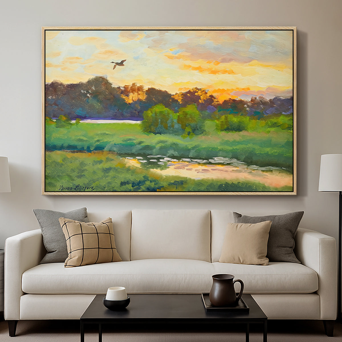 Flying Duck at Sunset, 1924 by Bruno Liljefors displayed in a natural wood floater framed canvas above a sofa in a clean living room.