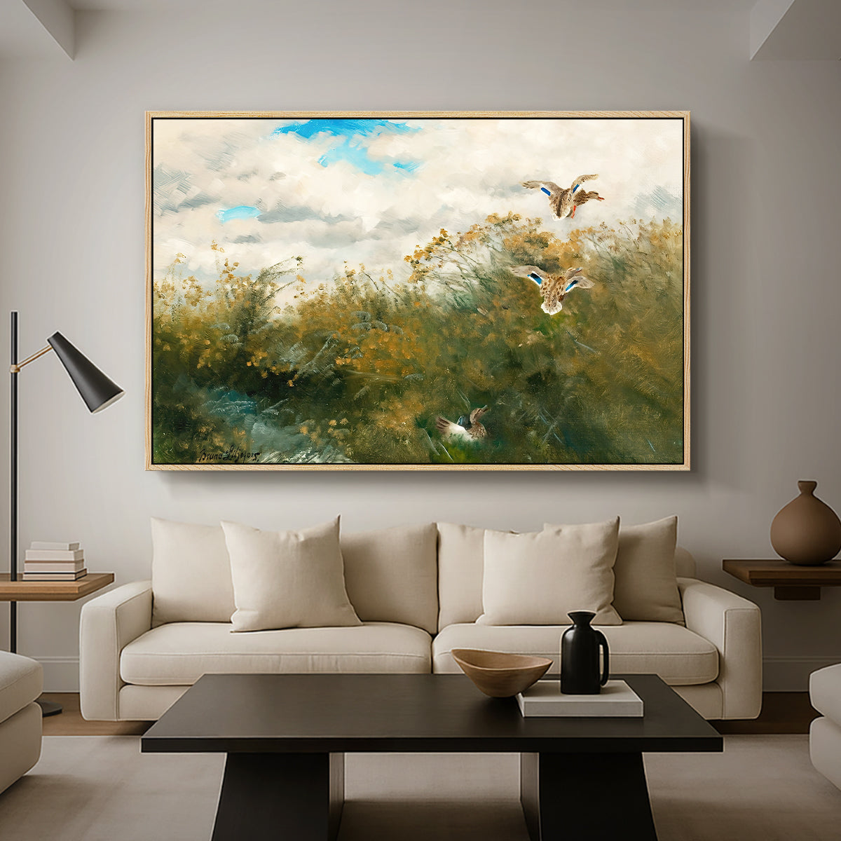 Wild Ducks (Grasänder), 1890 by Bruno Liljefors as a natural wood floater framed canvas featuring ducks moving through grassy wetland near water's edge, displayed above a sofa in a modern living room.