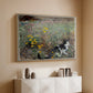 Natural wood floater framed canvas of Cat on a Flowery Meadow, 1887 by Bruno Liljefors, featuring a small cat resting among colorful flowers in grassy field above a console cabinet in a minimalist entryway.