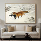 Fox in Snow Landscape, 1900 by Bruno Liljefors displayed in a natural wood floater framed canvas above a sofa in a clean living room.