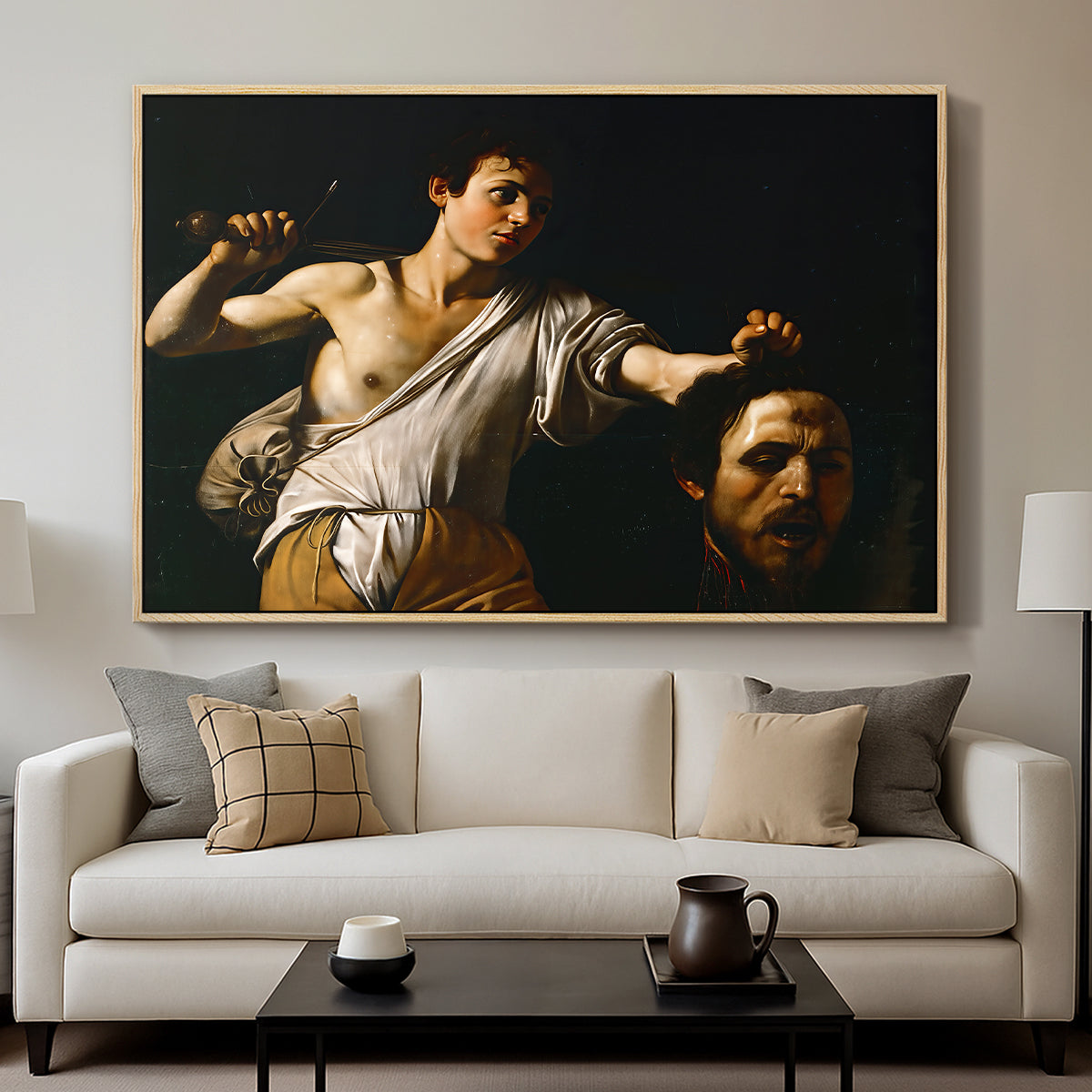 David with the Head of Goliath (Vienna Version), c. 1607 by Caravaggio displayed in a natural wood floater framed canvas above a sofa in a clean living room.