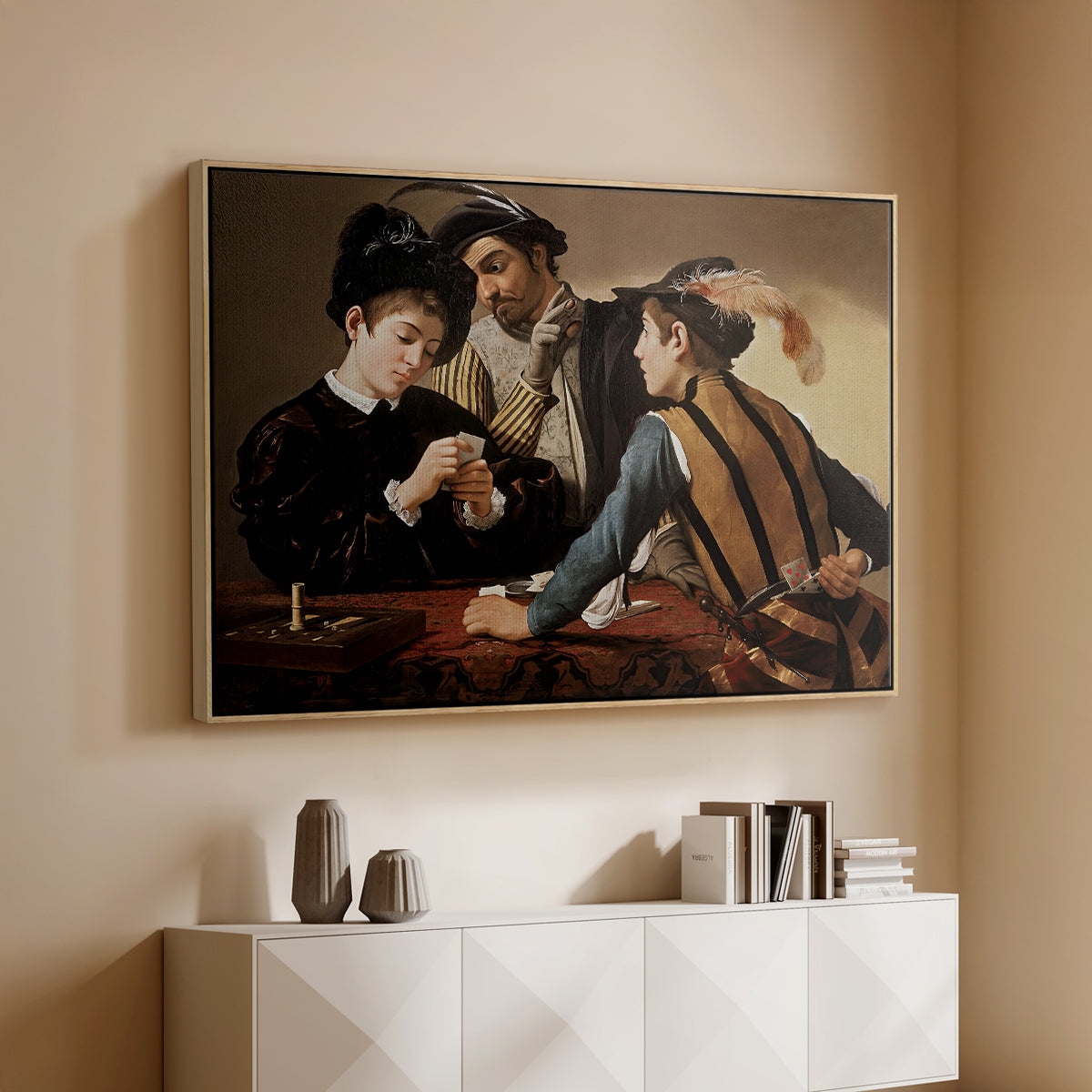 Natural wood floater framed canvas of The Cardsharps, c. 1594 by Caravaggio, featuring a genre scene of card game with deception and hidden accomplice above a console cabinet in a minimalist entryway.