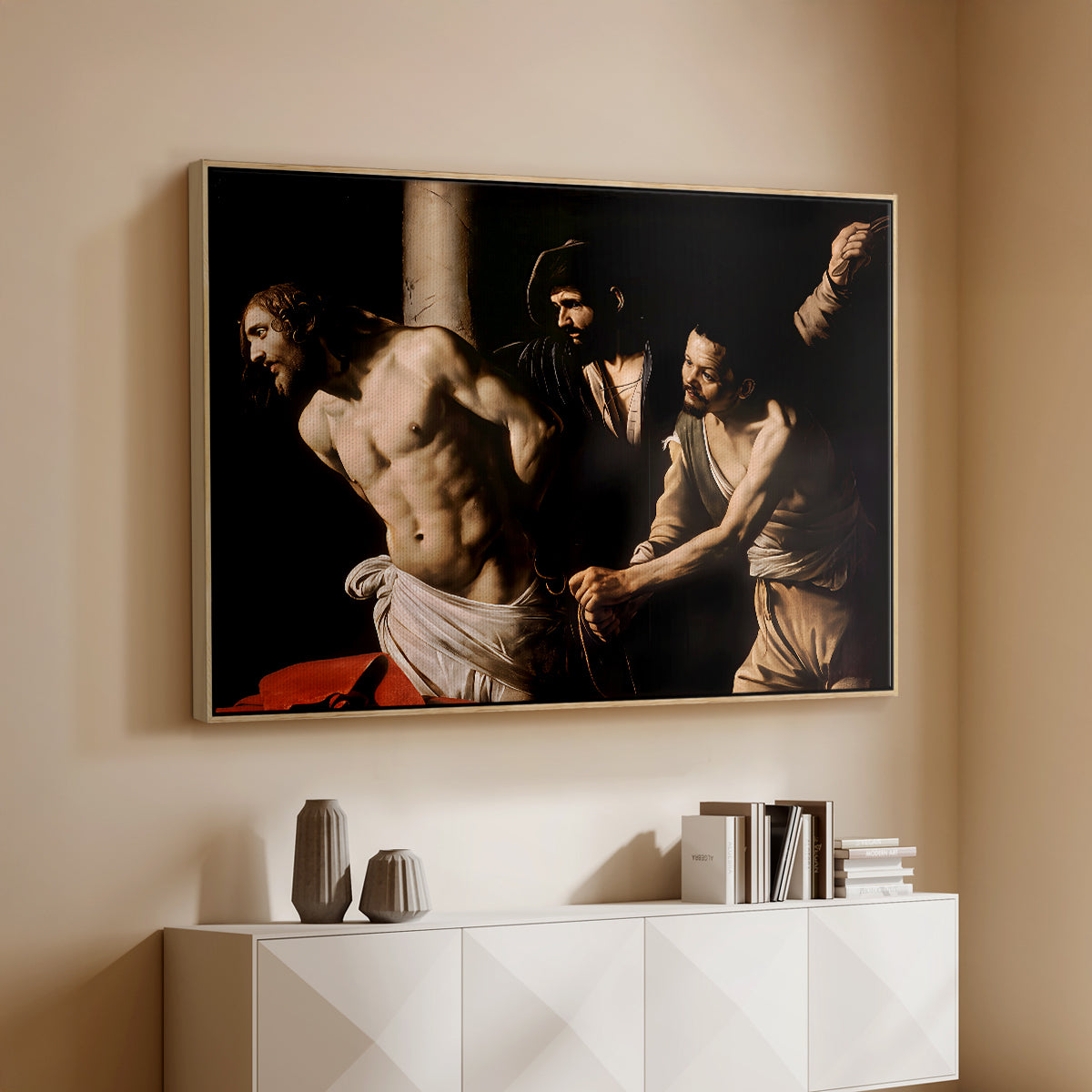 Natural wood floater framed canvas of The Flagellation of Christ at the Column (Rouen Version), 1606 by Caravaggio, featuring a dramatic religious scene of Christ enduring flagellation in dark interior above a console cabinet in a minimalist entryway.