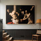 Natural wood floater framed canvas featuring an intense Baroque scene of suffering with strong light and shadow, displayed in a hallway near a staircase.