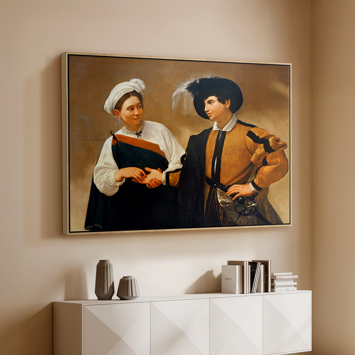 Natural wood floater framed canvas of The Fortune Teller (Capitoline Version), c. 1599 by Caravaggio, featuring a fortune teller tricking young man during palm reading above a console cabinet in a minimalist entryway.