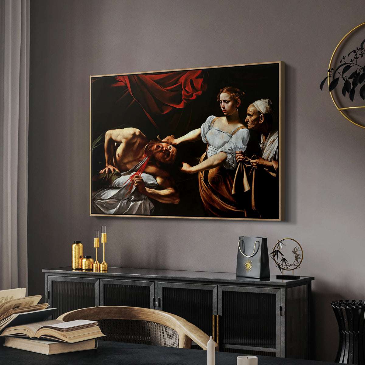Judith Beheading Holofernes, c. 1599 by Caravaggio in a natural wood floater framed canvas featuring an intense moment of Judith slaying Holofernes with sword, displayed above a desk in a dark home office interior.