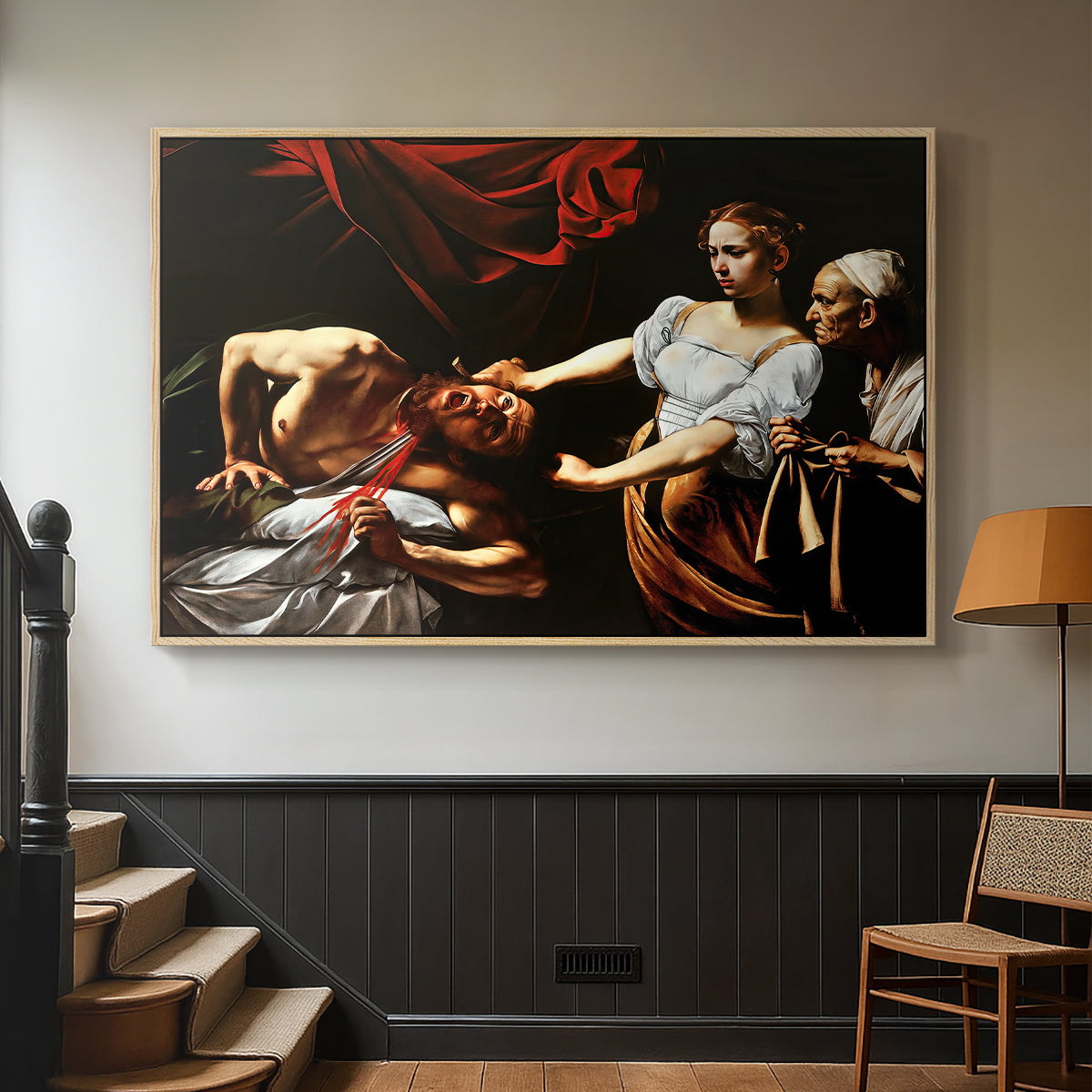 Natural wood floater framed canvas featuring a violent religious narrative with strong contrast of light and shadow, displayed in a hallway near a staircase.
