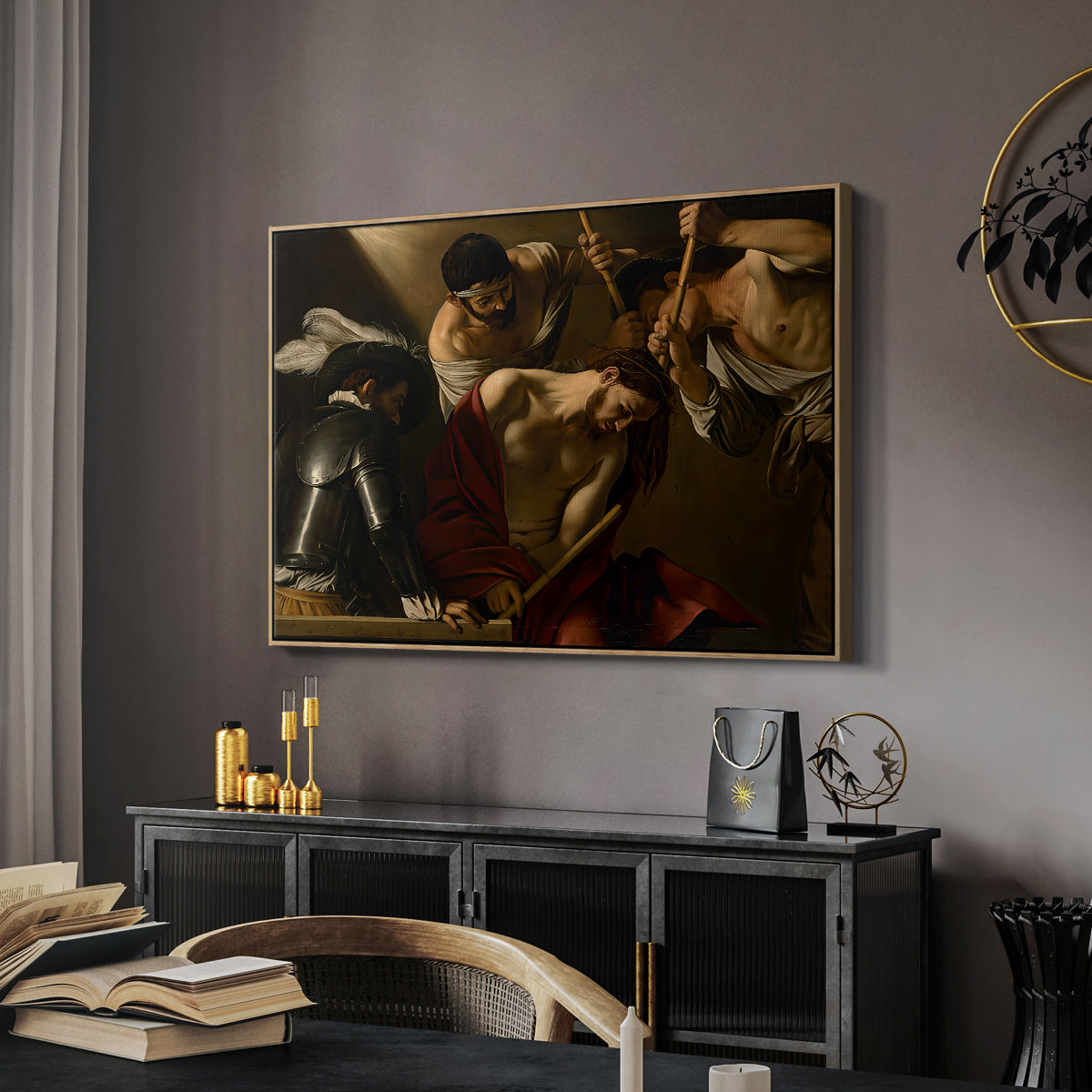 The Crowning with Thorns (Vienna Version), c. 1602-1604 by Caravaggio in a natural wood floater framed canvas featuring a dramatic depiction of figures forcing thorn crown onto Christ, displayed above a desk in a dark home office interior.