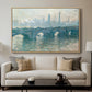 Waterloo Bridge, Gray Weather, 1900 by Claude Monet displayed in a natural wood floater framed canvas above a sofa in a clean living room.