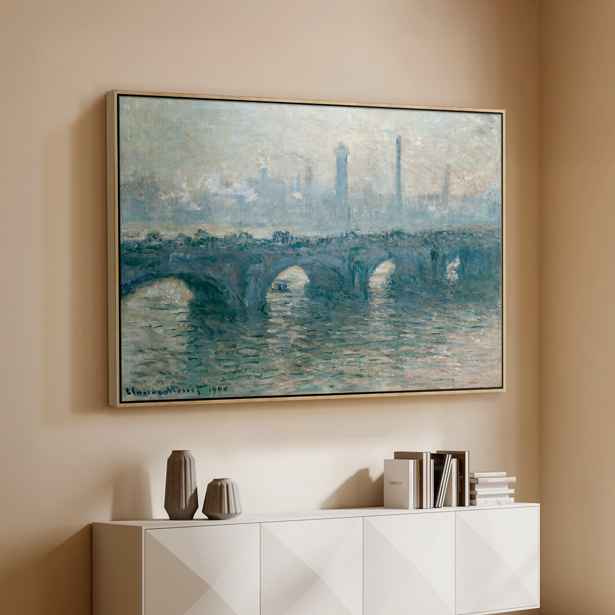 Natural wood floater framed canvas of Waterloo Bridge, Gray Weather, 1900 by Claude Monet, featuring an impressionist cityscape with bridge fading into fog over water above a console cabinet in a minimalist entryway.