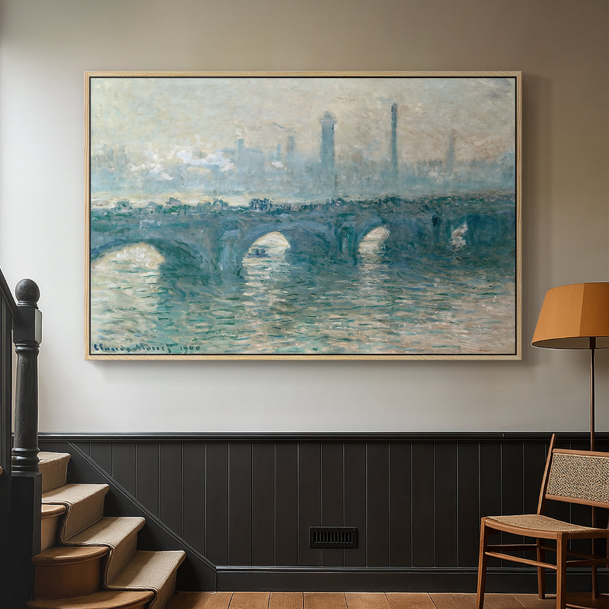 Natural wood floater framed canvas featuring an atmospheric urban landscape with misty light and reflections, displayed in a hallway near a staircase.
