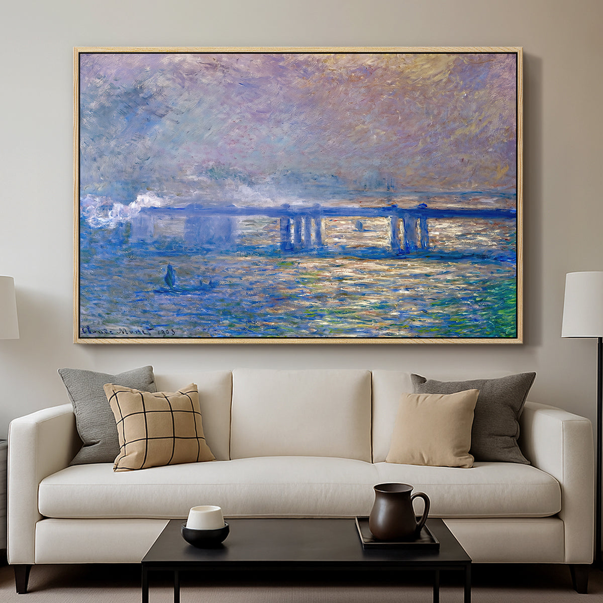 Charing Cross Bridge, 1903 by Claude Monet displayed in a natural wood floater framed canvas above a sofa in a clean living room.
