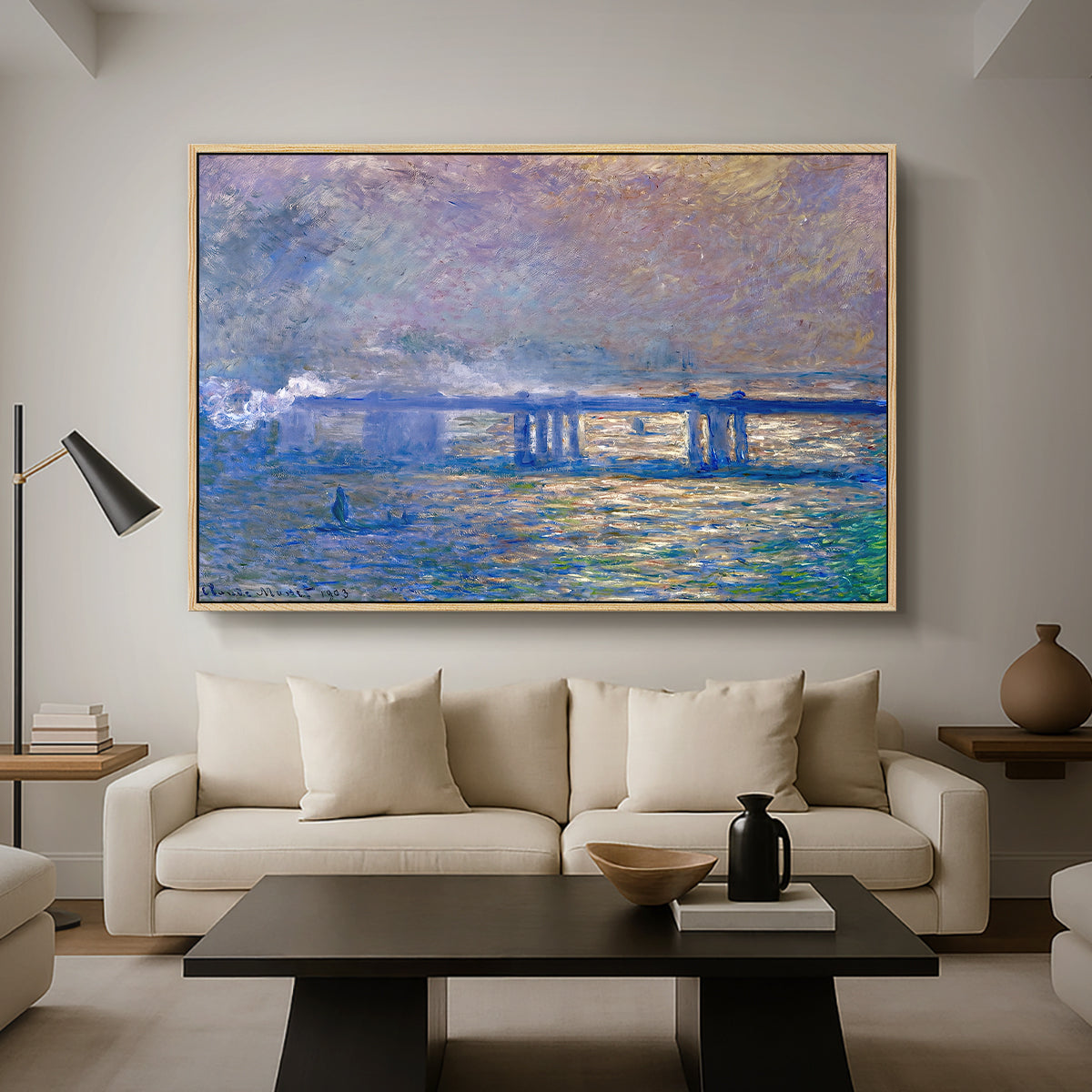 Charing Cross Bridge, 1903 by Claude Monet as a natural wood floater framed canvas featuring an impressionist view of bridge stretching across river with soft light and haze, displayed above a sofa in a modern living room.