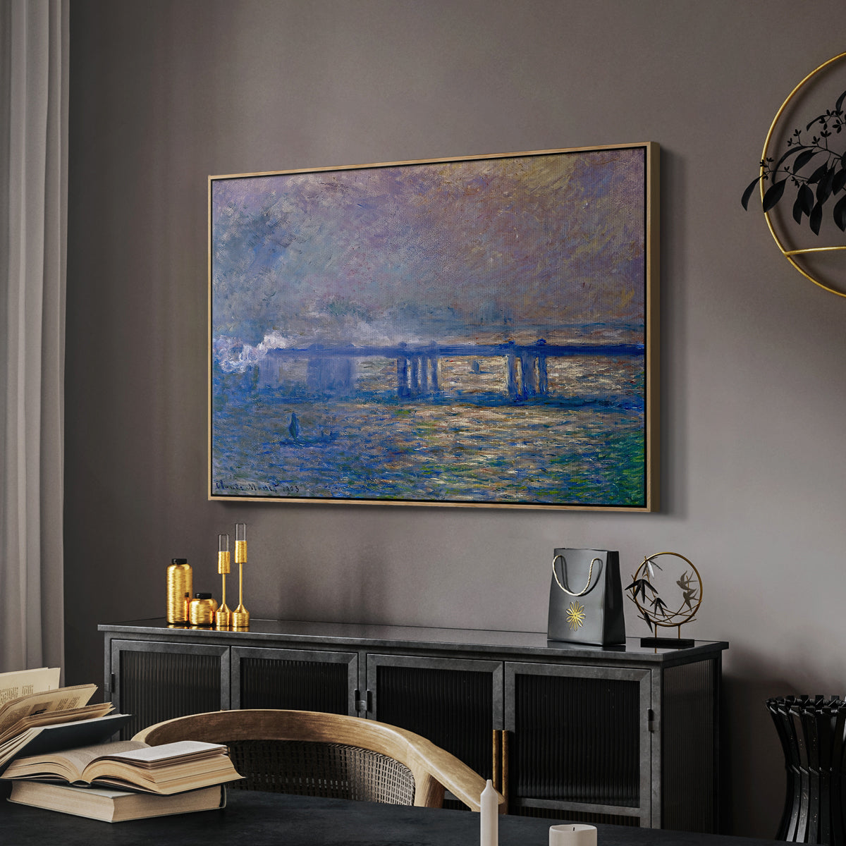 Charing Cross Bridge, 1903 by Claude Monet in a natural wood floater framed canvas featuring an atmospheric depiction of London bridge with reflections in water, displayed above a desk in a dark home office interior.