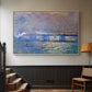 Natural wood floater framed canvas featuring a city bridge scene softened by mist and impressionist brushwork, displayed in a hallway near a staircase.