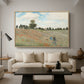 The Poppy Field near Argenteuil, 1873 by Claude Monet as a natural wood floater framed canvas featuring a field of red poppies with figures walking across rolling landscape, displayed above a sofa in a modern living room.
