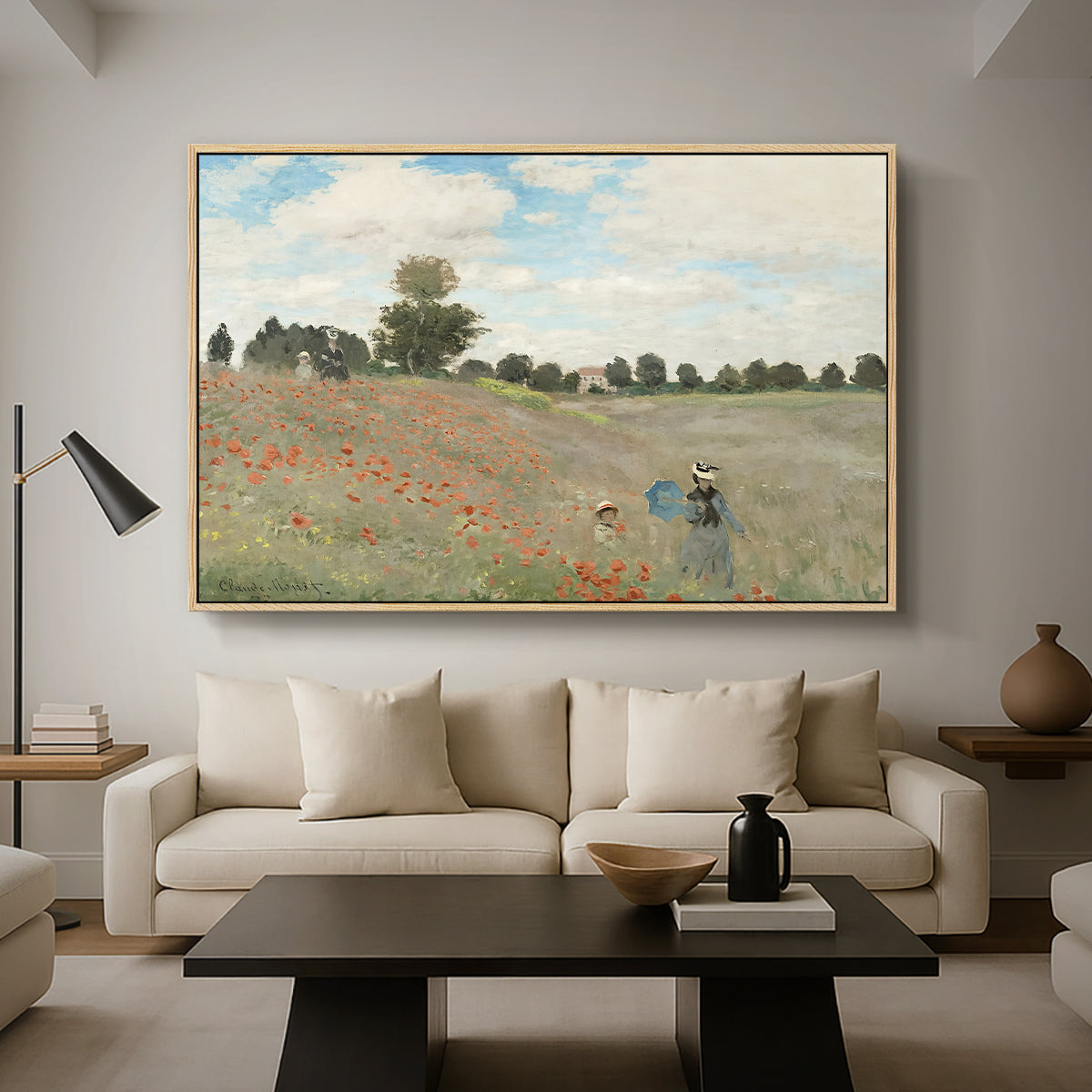 The Poppy Field near Argenteuil, 1873 by Claude Monet as a natural wood floater framed canvas featuring a field of red poppies with figures walking across rolling landscape, displayed above a sofa in a modern living room.