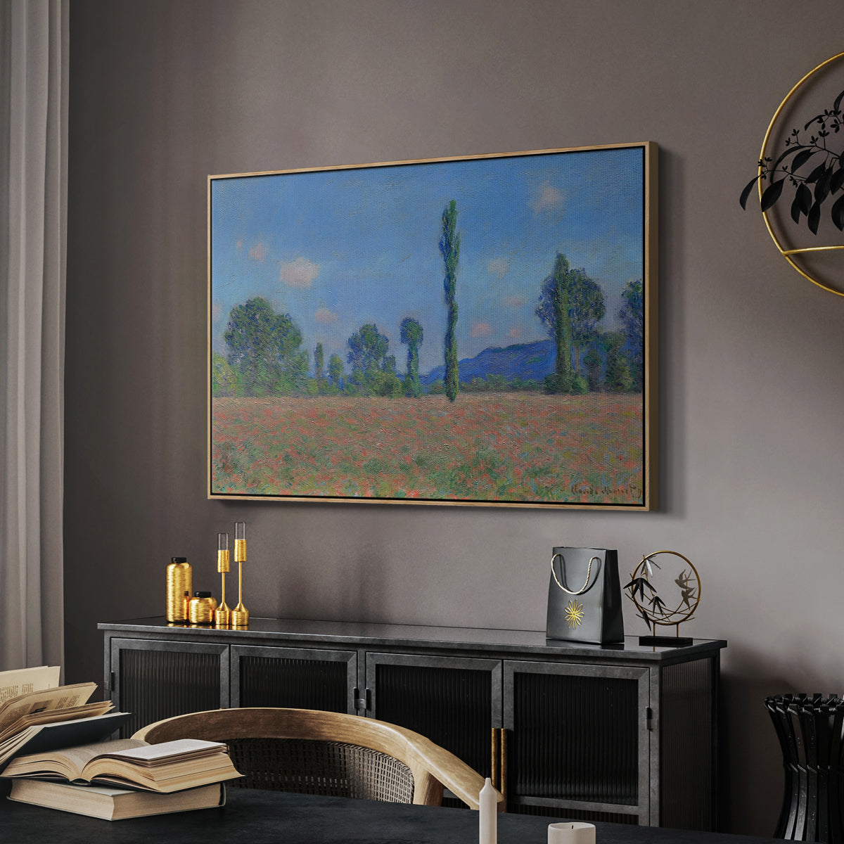 Poppy Field (Giverny), 1890-1891 by Claude Monet in a natural wood floater framed canvas featuring a vibrant meadow scene with flowers and vertical tree forms, displayed above a desk in a dark home office interior.