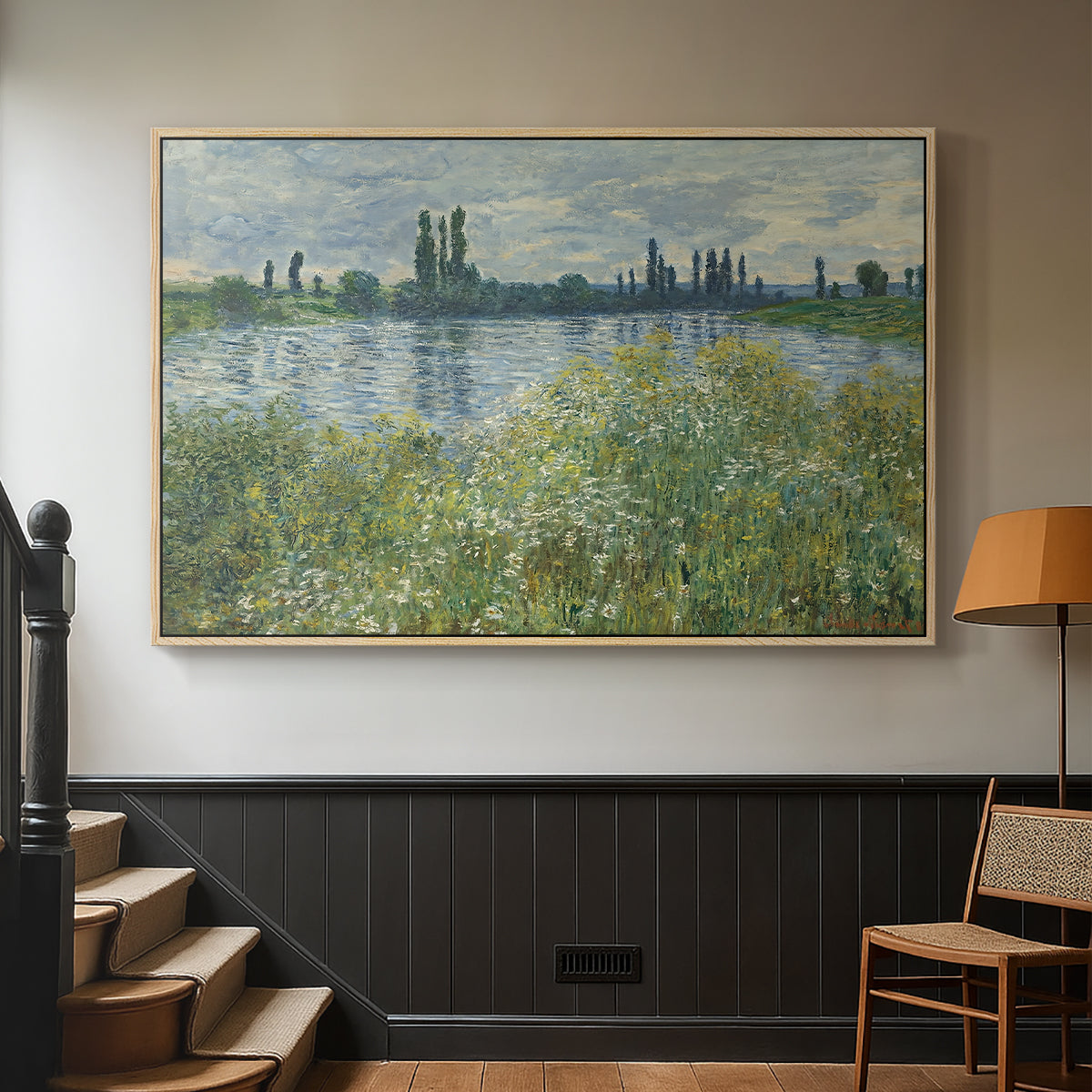 Natural wood floater framed canvas featuring a natural landscape with calm water and soft foliage, displayed in a hallway near a staircase.