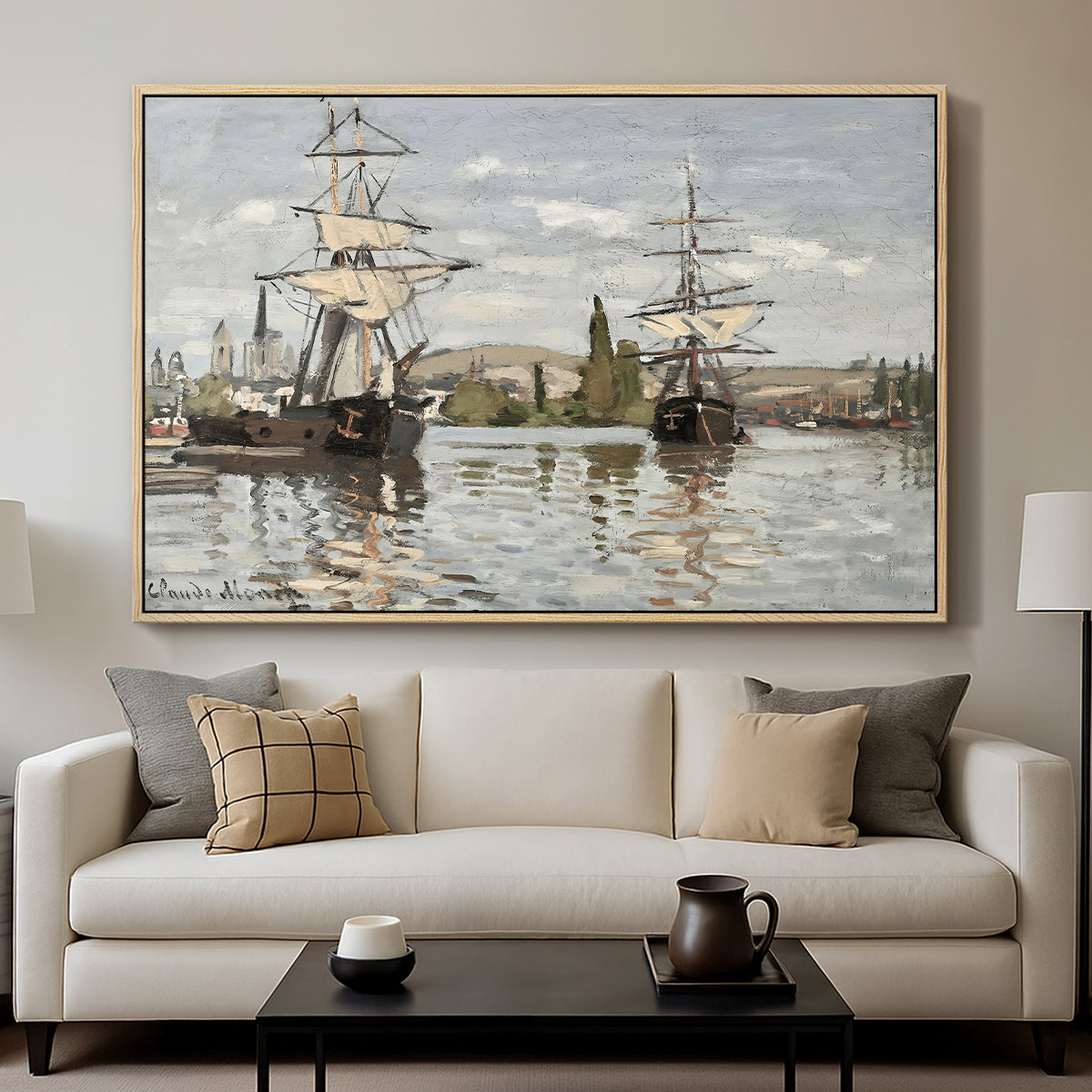 Ships Riding on the Seine at Rouen, 1872 by Claude Monet displayed in a natural wood floater framed canvas above a sofa in a clean living room.