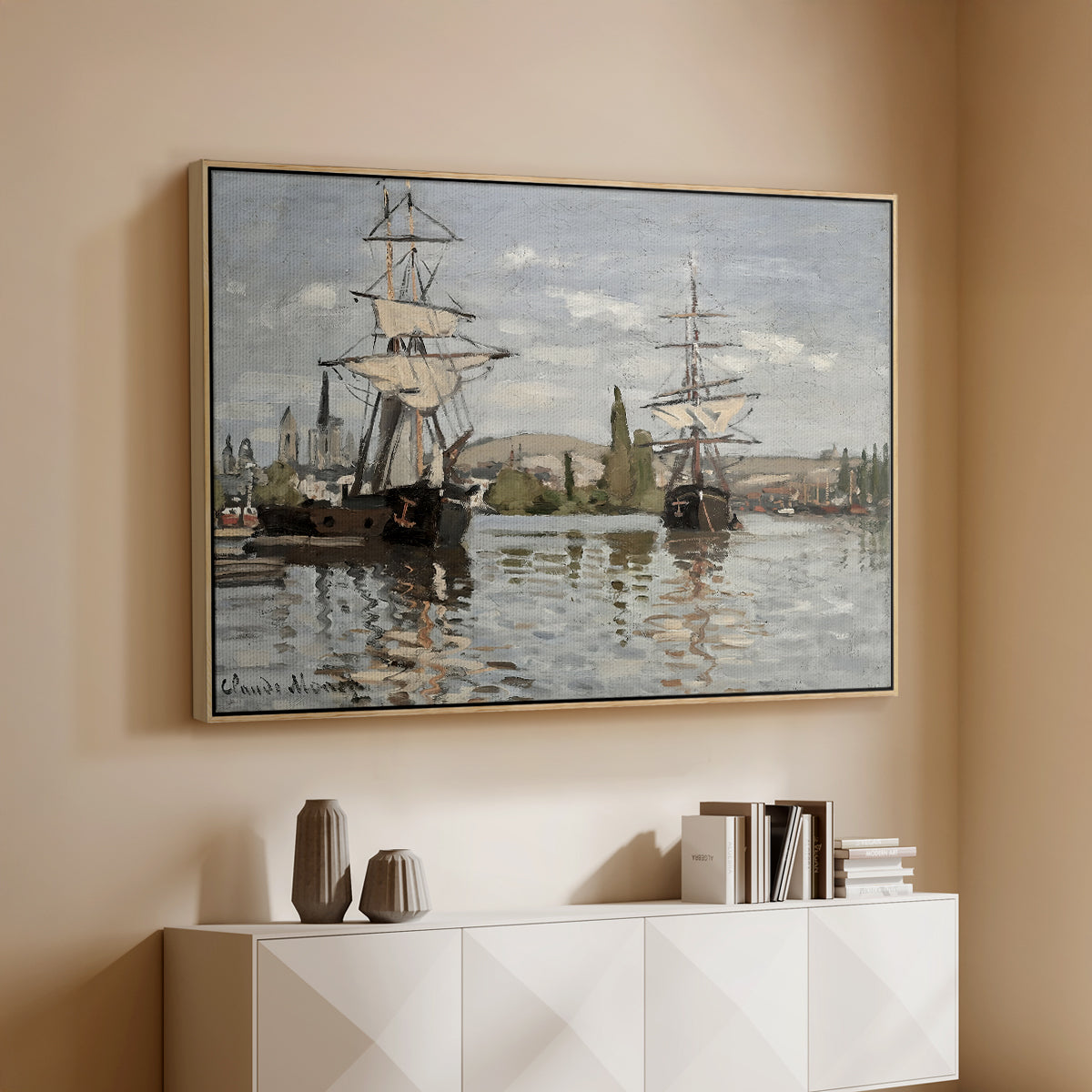 Natural wood floater framed canvas of Ships Riding on the Seine at Rouen, 1872 by Claude Monet, featuring an impressionist river scene with anchored sailing ships and reflections above a console cabinet in a minimalist entryway.