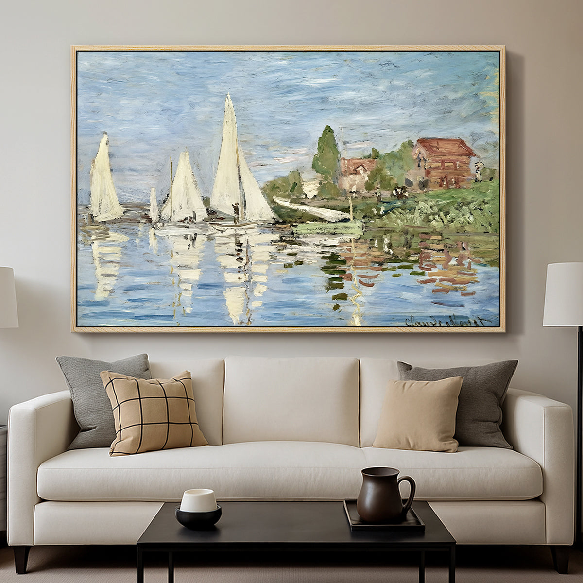 Regatta at Argenteuil, 1872 by Claude Monet displayed in a natural wood floater framed canvas above a sofa in a clean living room.