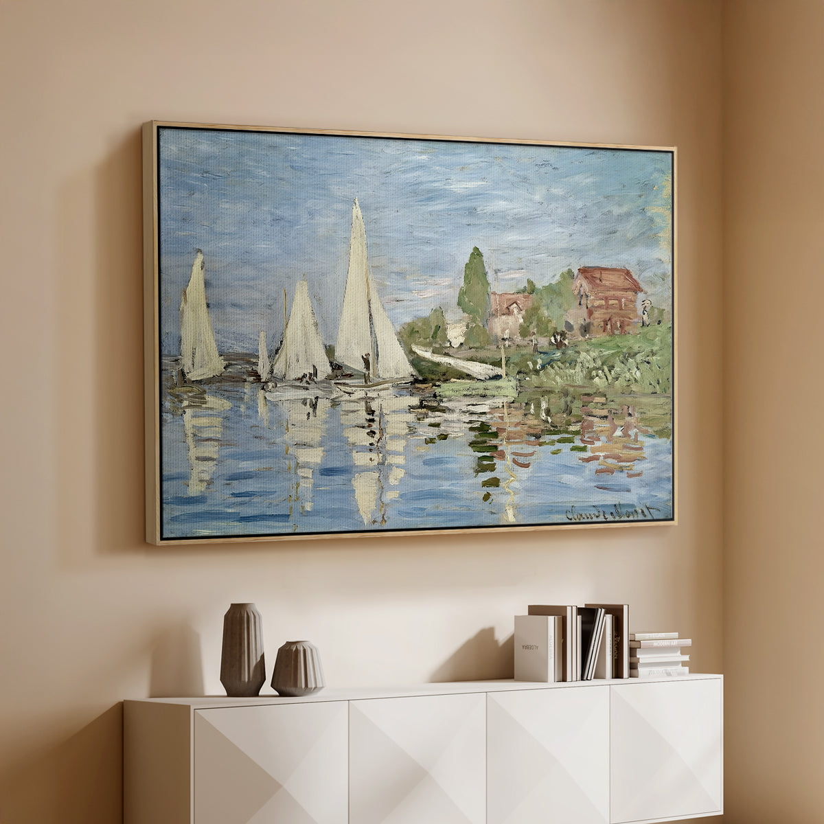 Natural wood floater framed canvas of Regatta at Argenteuil, 1872 by Claude Monet, featuring a lively regatta scene with multiple boats and fluttering sails above a console cabinet in a minimalist entryway.