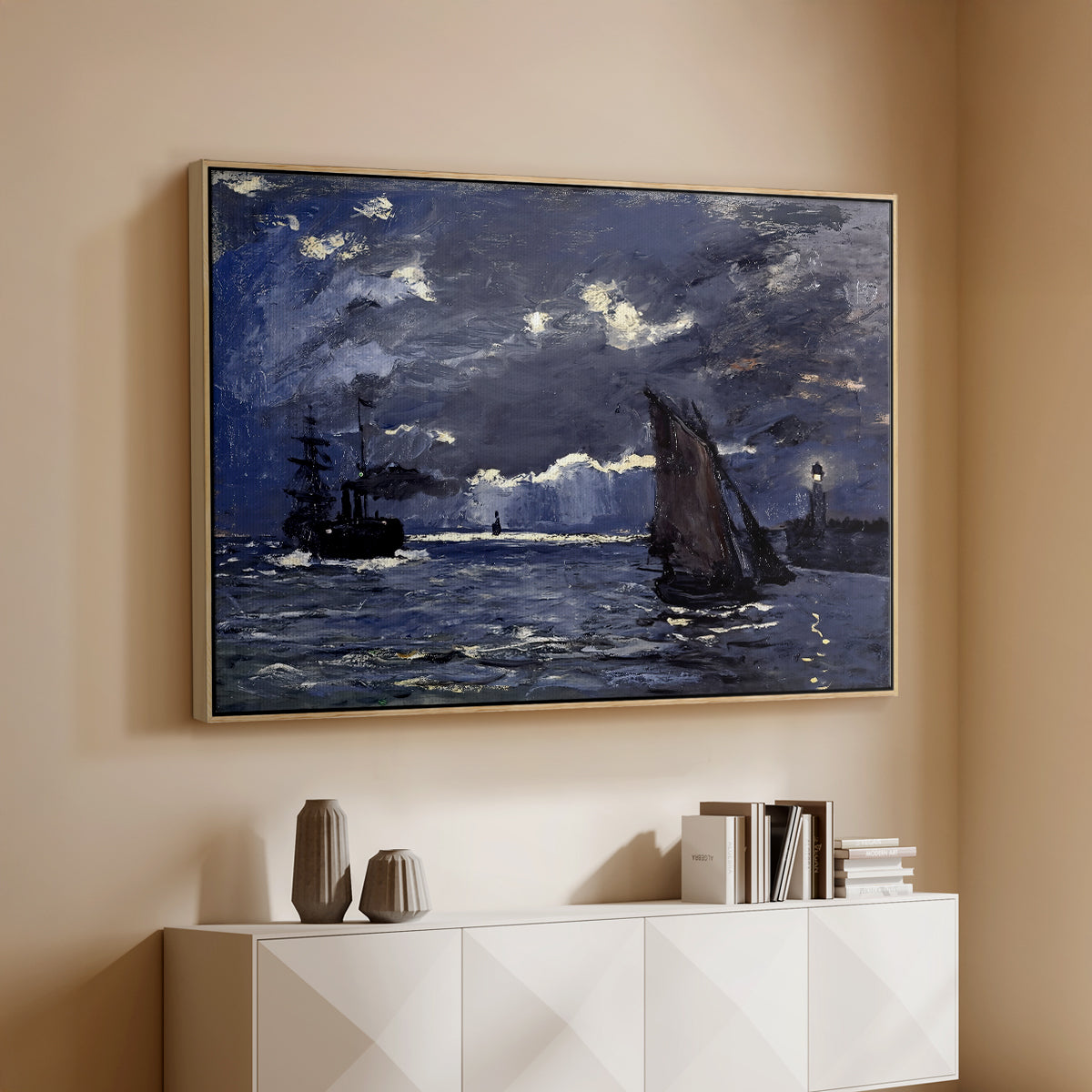 Natural wood floater framed canvas of A Seascape, Shipping by Moonlight, 1864 by Claude Monet, featuring a nocturnal seascape with boats silhouetted against glowing moon above a console cabinet in a minimalist entryway.