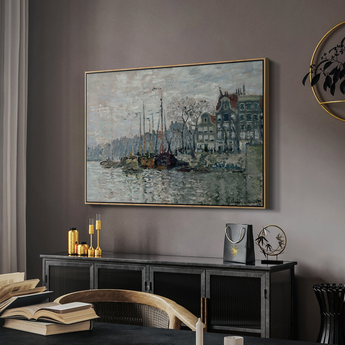 View of the Prins Hendrikkade and Kromme Waal in Amsterdam, 1874 by Claude Monet in a natural wood floater framed canvas featuring an urban waterway with docked boats and European buildings, displayed above a desk in a dark home office interior.