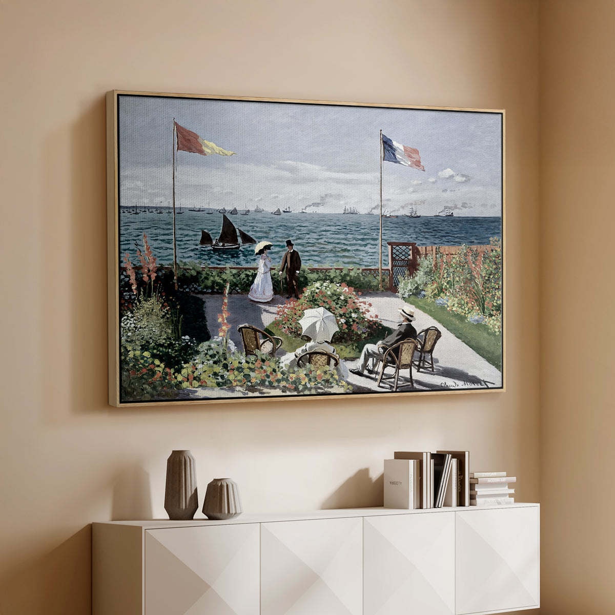 Natural wood floater framed canvas of Garden at Sainte-Adresse, 1867 by Claude Monet, featuring an impressionist coastal garden with people and ocean view above a console cabinet in a minimalist entryway.