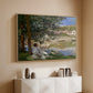 Natural wood floater framed canvas of On the Bank of the Seine, Bennecourt, 1868 by Claude Monet, featuring a peaceful riverside scene with figures resting in grassy area by water above a console cabinet in a minimalist entryway.