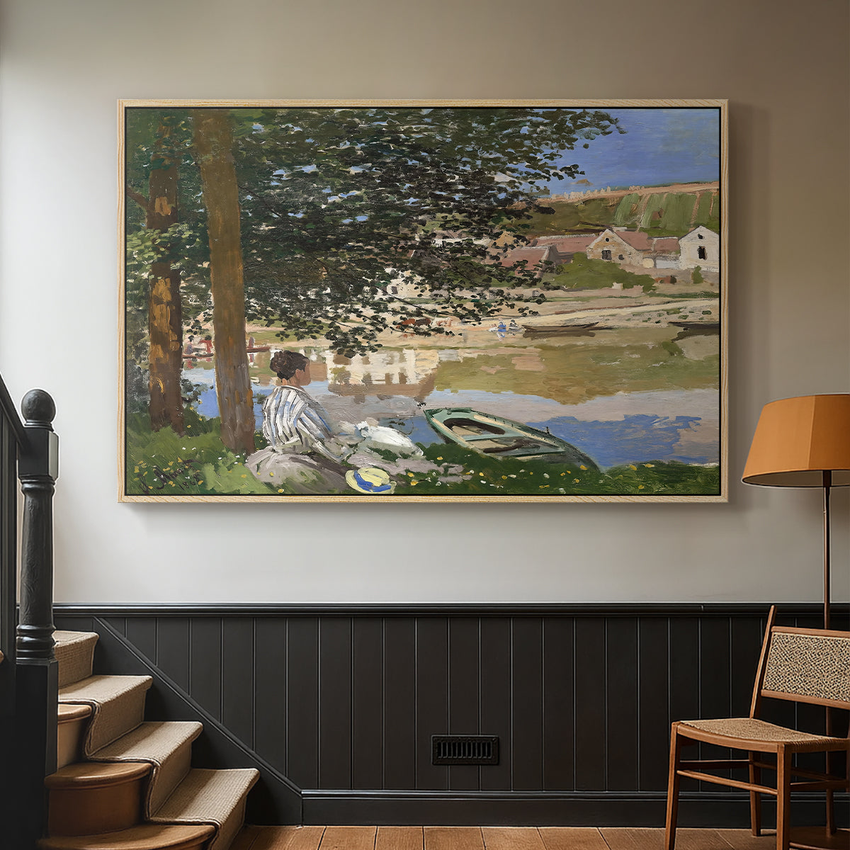 Natural wood floater framed canvas featuring a quiet outdoor setting with figures near river under foliage, displayed in a hallway near a staircase.