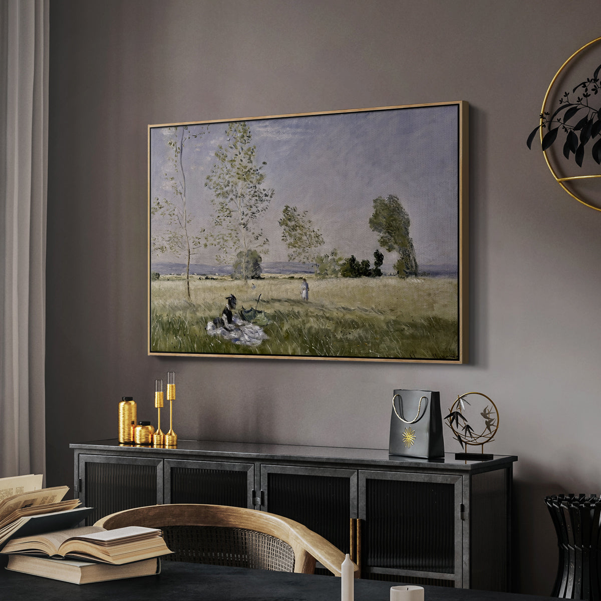 Summer (L'ete), 1874 by Claude Monet in a natural wood floater framed canvas featuring a sunlit meadow with woman surrounded by greenery, displayed above a desk in a dark home office interior.