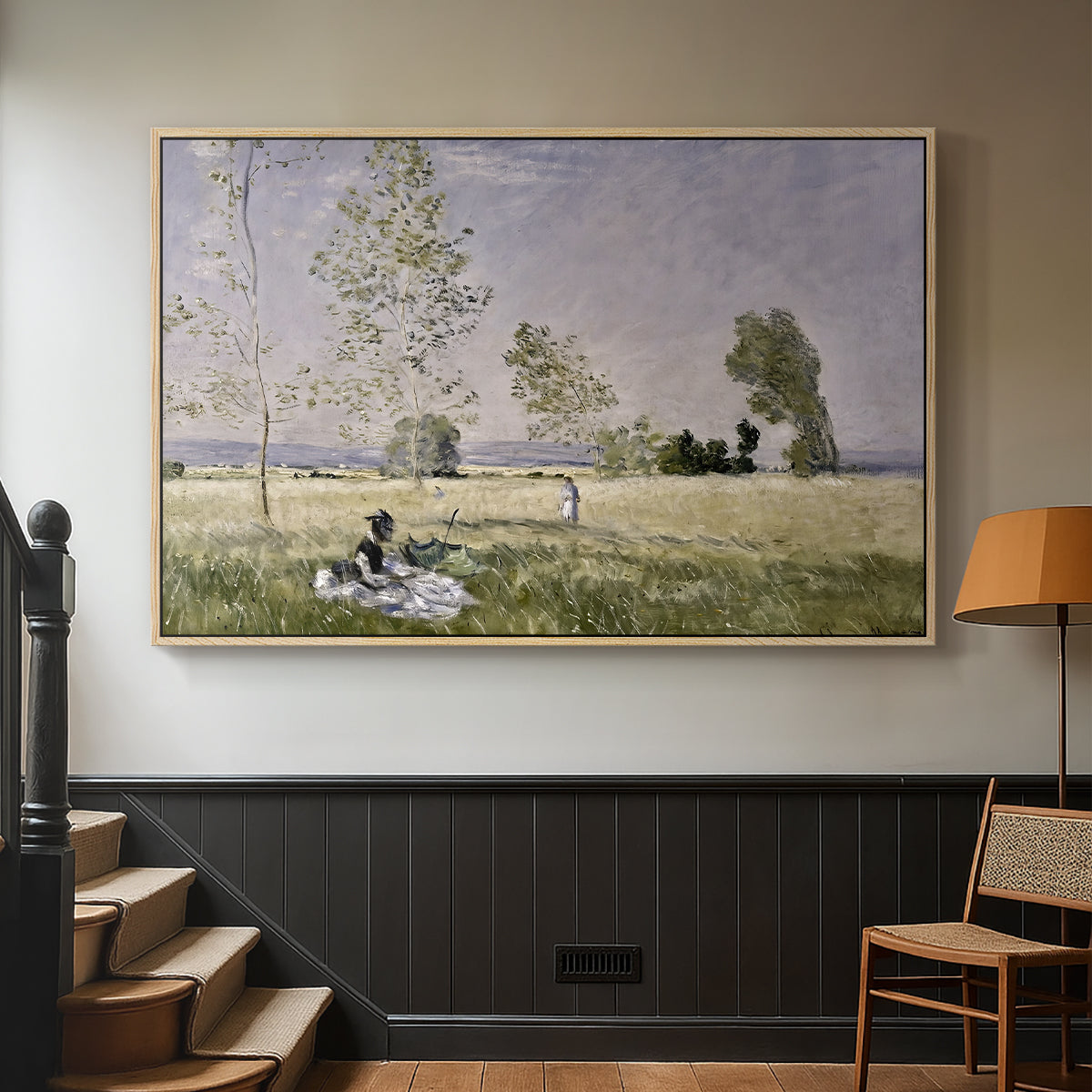 Natural wood floater framed canvas featuring a tranquil summer landscape with lone figure in nature, displayed in a hallway near a staircase.
